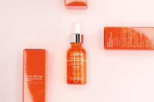 A Jumiso All day Vitamin Brightening And Balancing Serum dropper bottle in the middle with 2 of its outer boxes in either side, one placed horizontally and one placed vertically: one of the top sea buckthorn products on our list