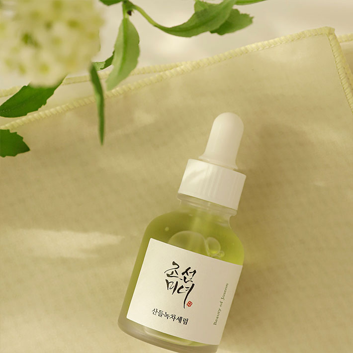 Beauty of Joseon Calming serum placed near a plant